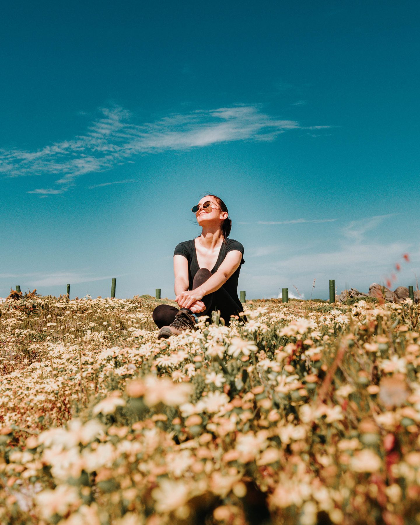 girl sitting next to postberg wildflowers
