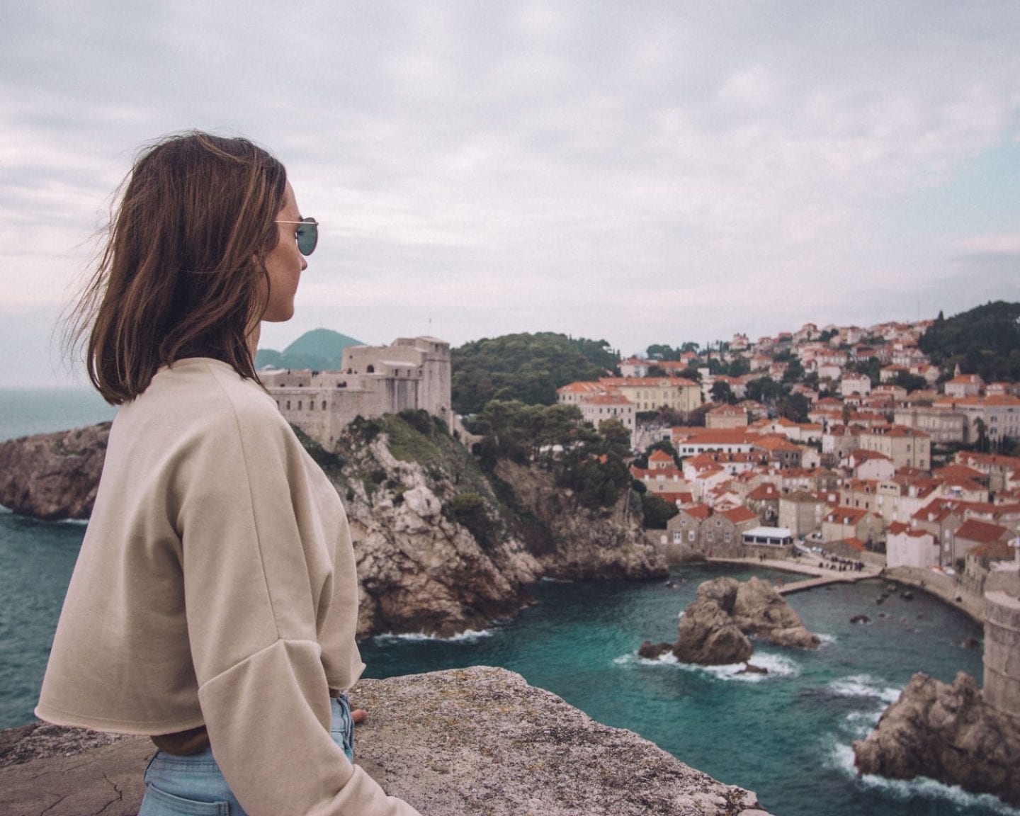 brunette standing on old city walls in dubrovnik