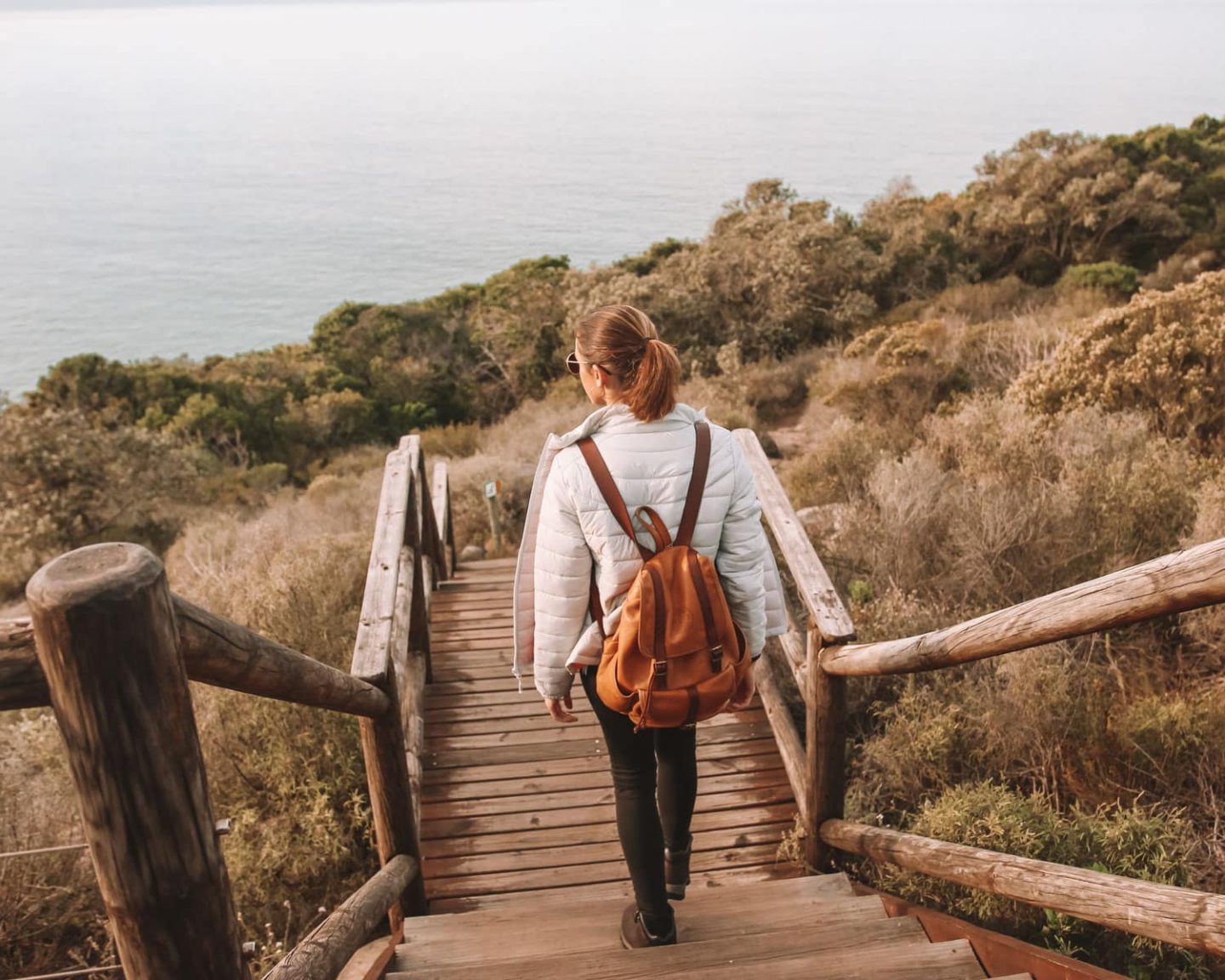 girl walking along the wooden boardwalks at robberg nature reserve