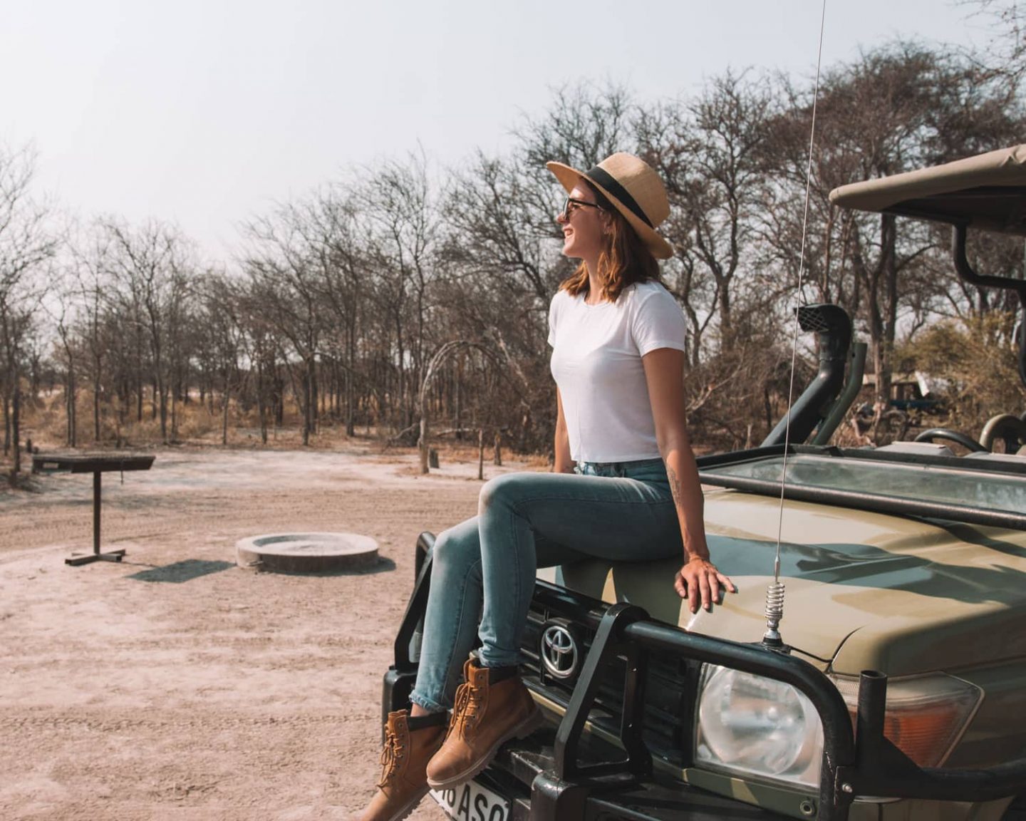 girl sitting on game drive vehicle