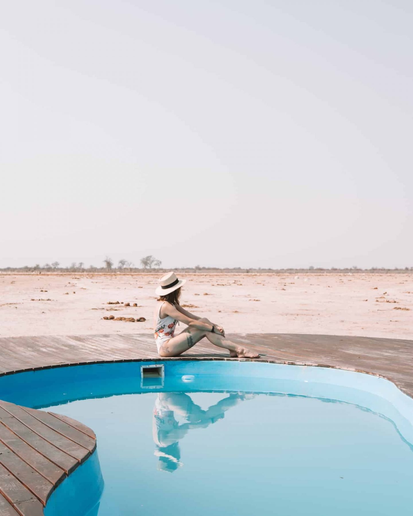 girl sitting by the pool at nxai pan camp