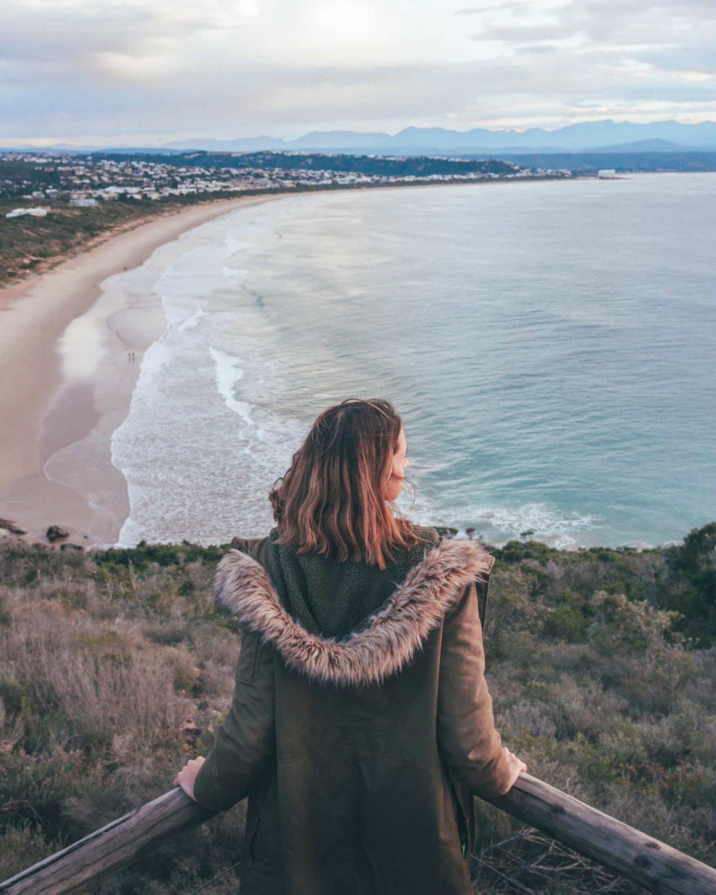 girl looking at the ocean in plettenberg bay