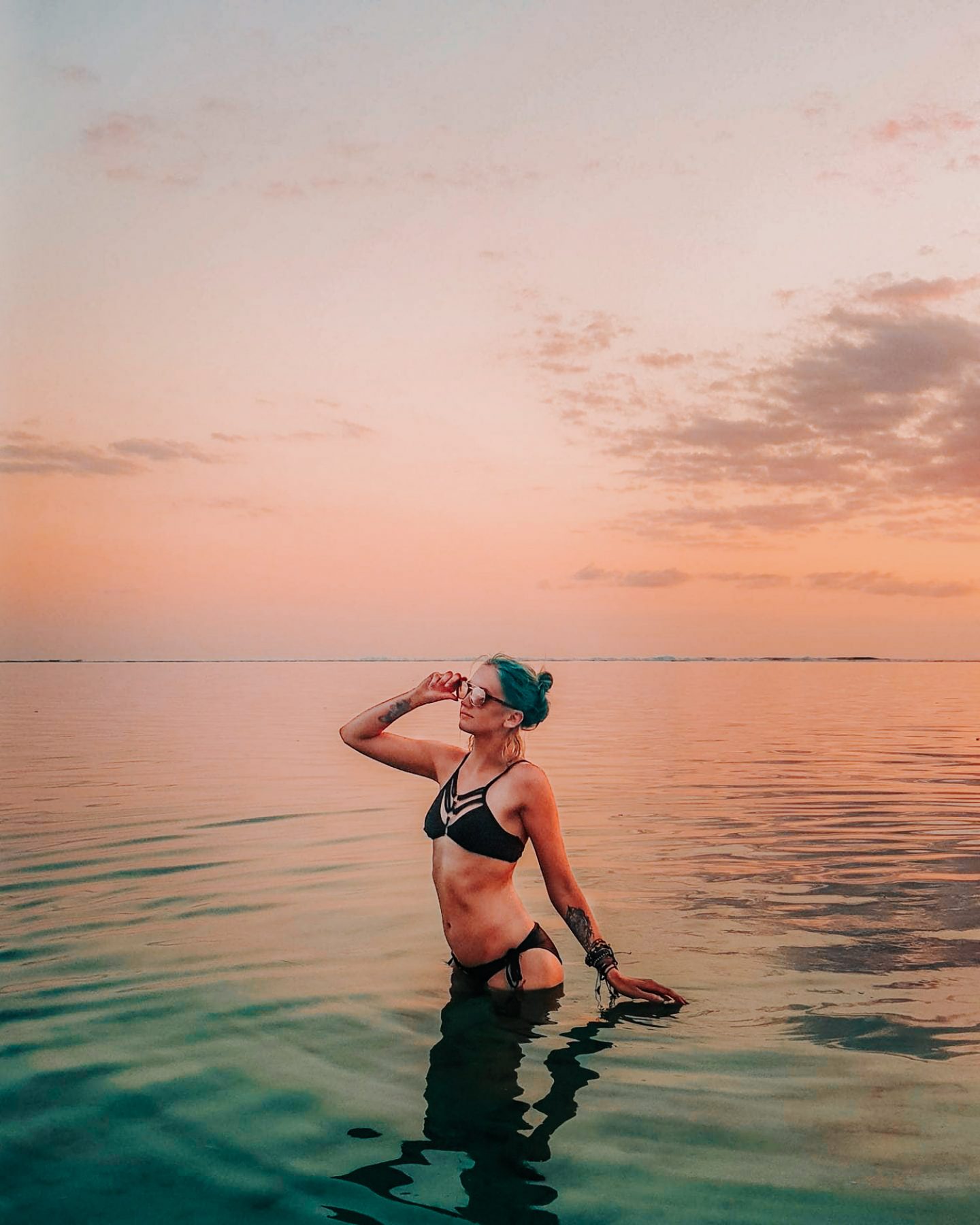 girl in reunion island on the beach at sunset