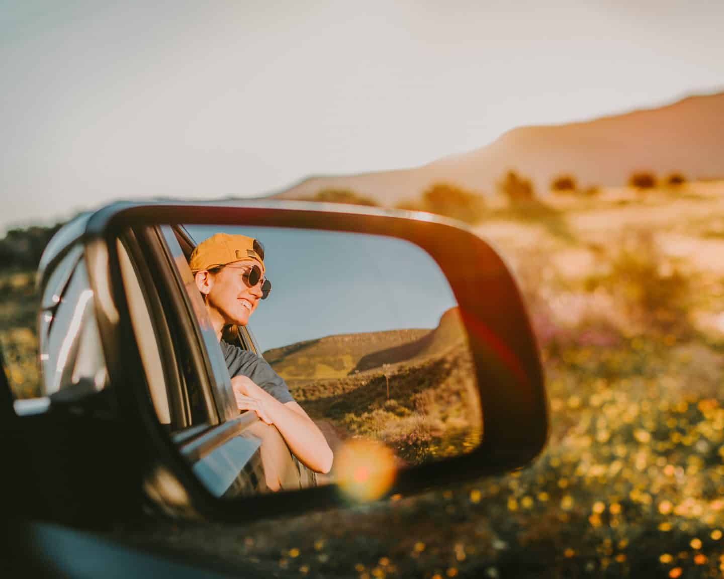 girl leaning out of car window