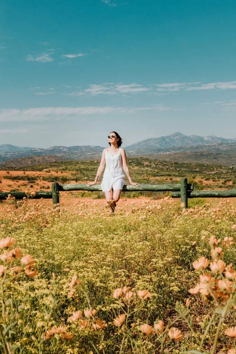 girl by wildflowers in namaqua national park