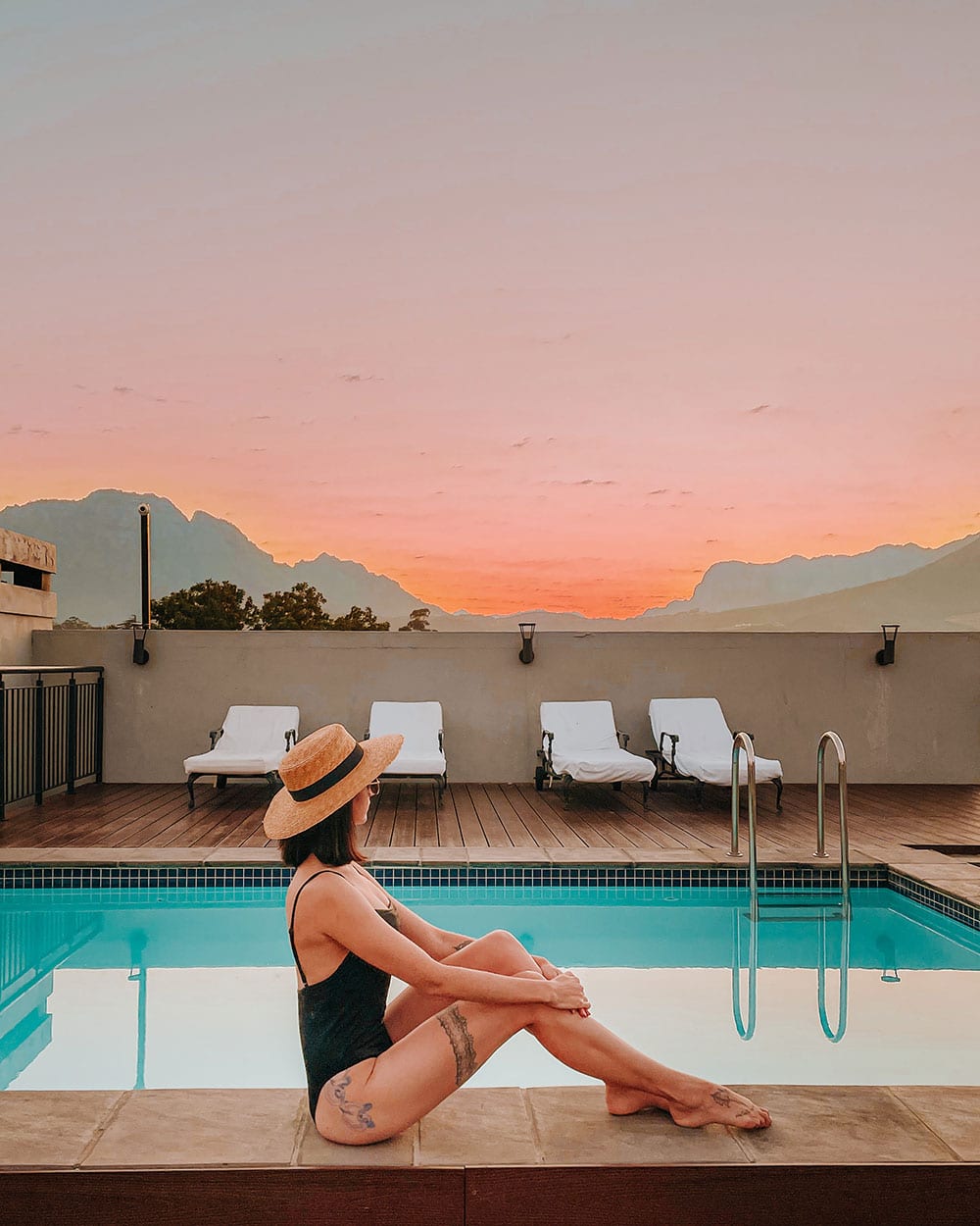 girl sitting across from a pool