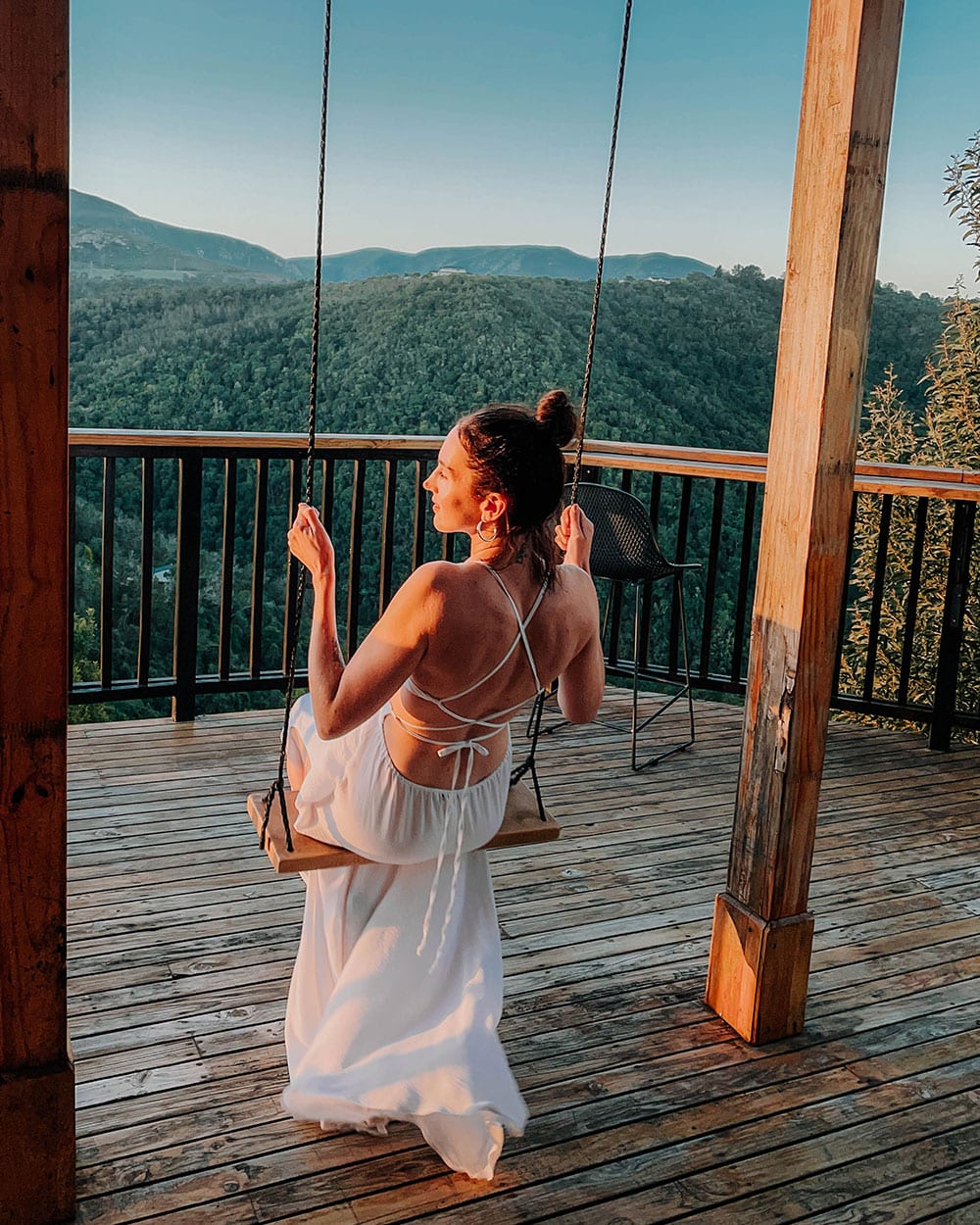 girl in white dress on swing