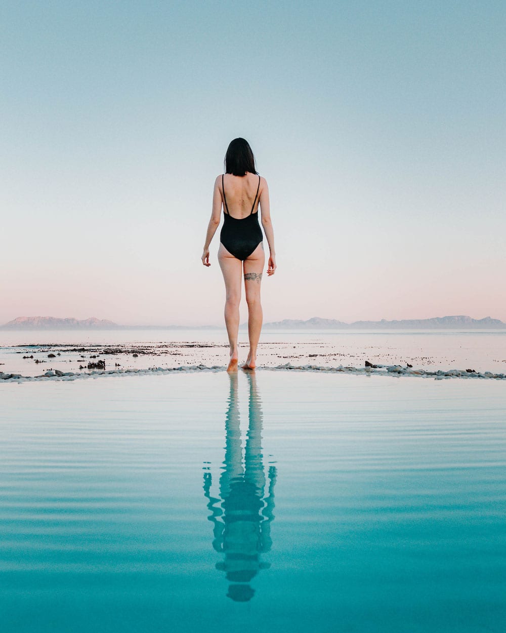 girl standing on the edge of a pool