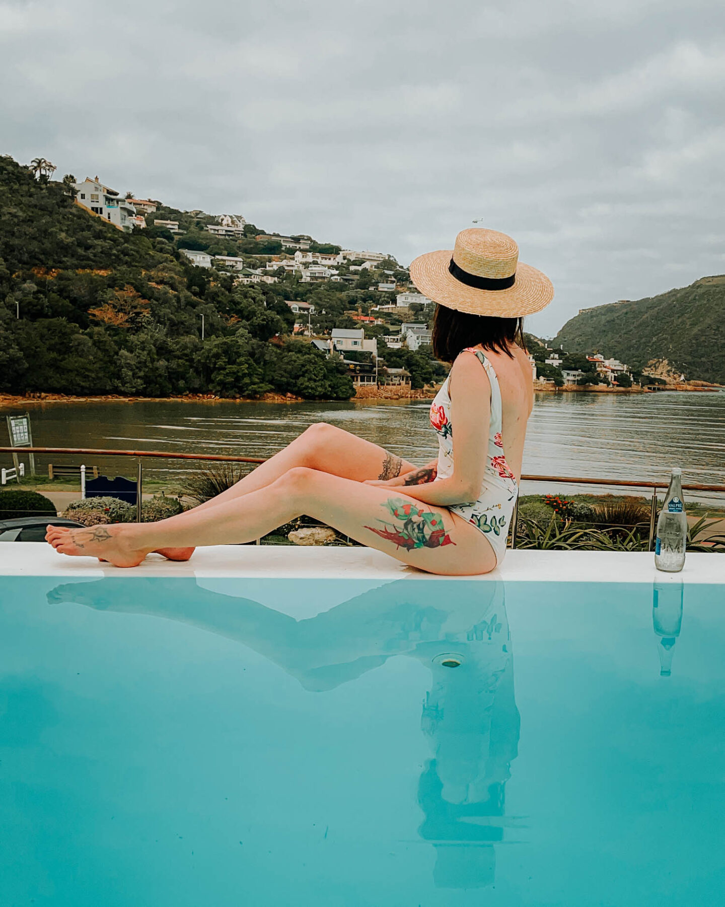 girl sitting next to pool