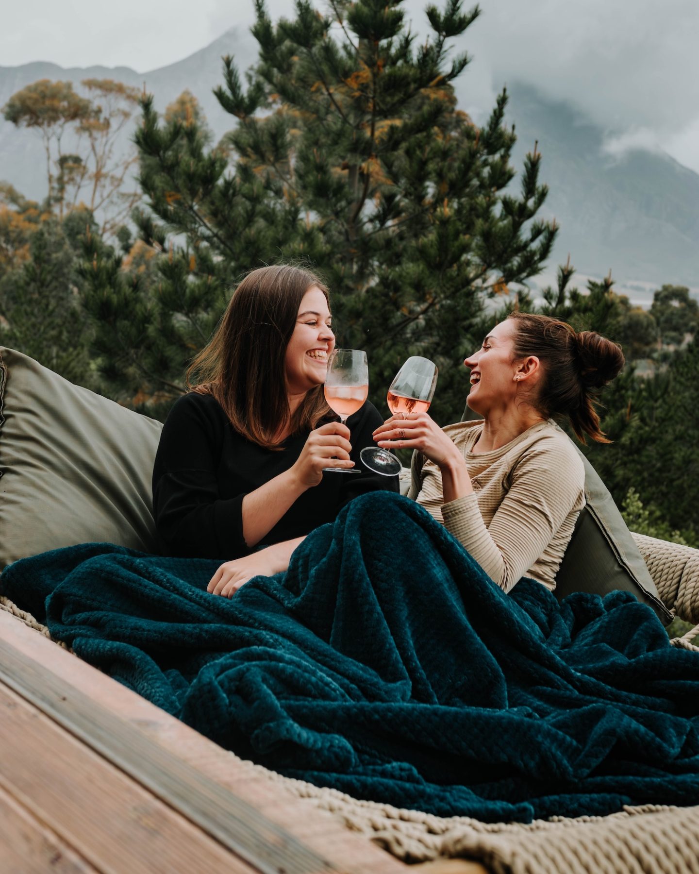 two women drinking wine at a cabin in tulbagh