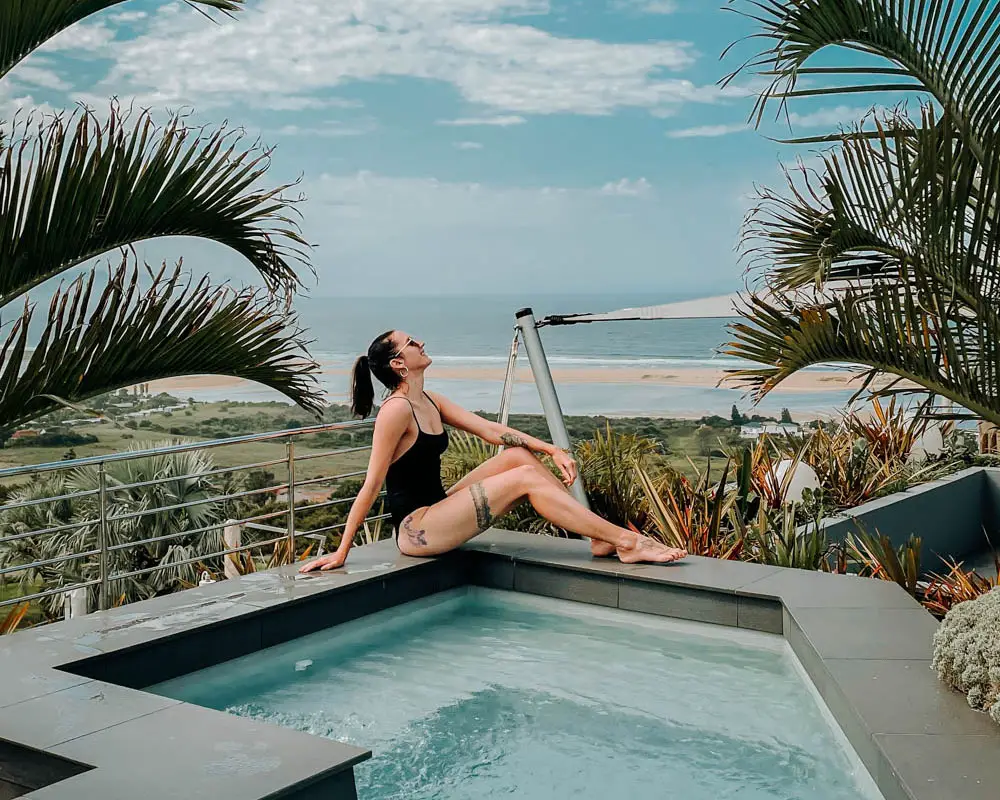 girl in plettenberg bay sitting next to a pool