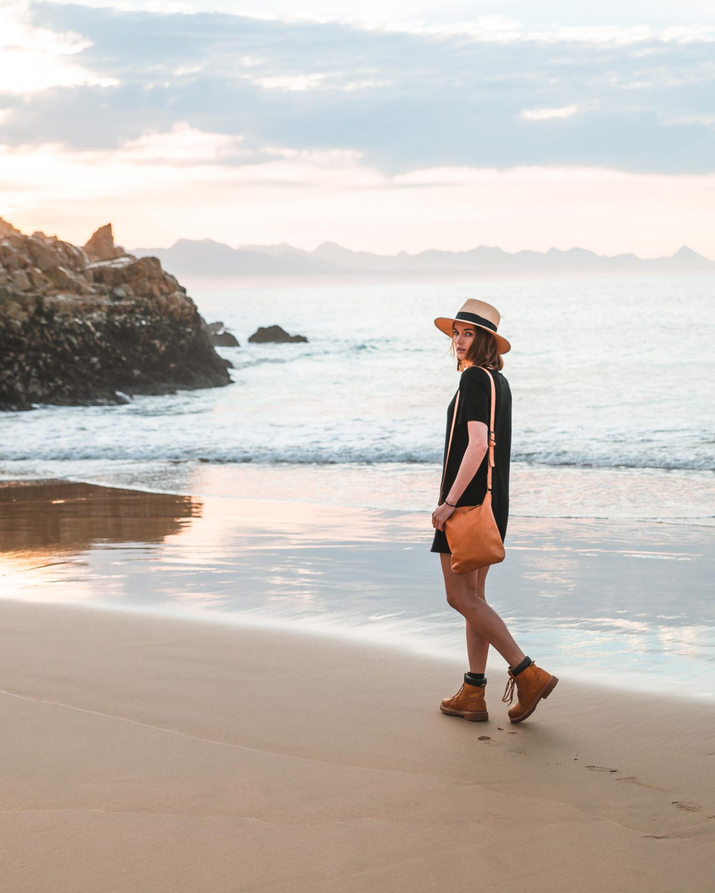 girl walking on beach in plettenberg bay