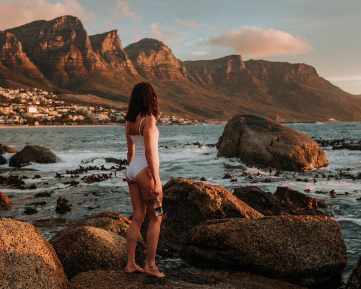 lauren standing on a rock at maidens cove in cape town