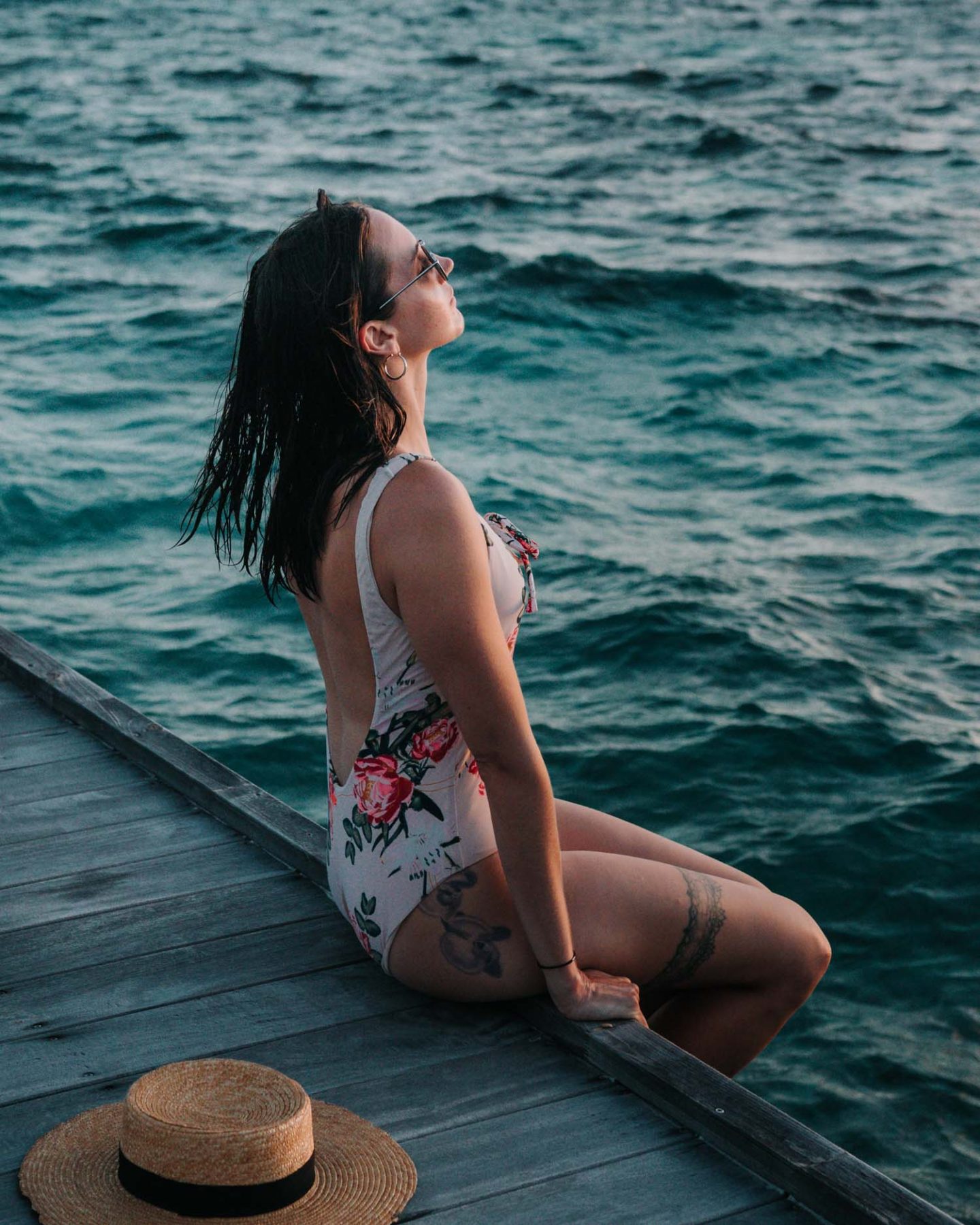 girl sitting on a deck over the ocean