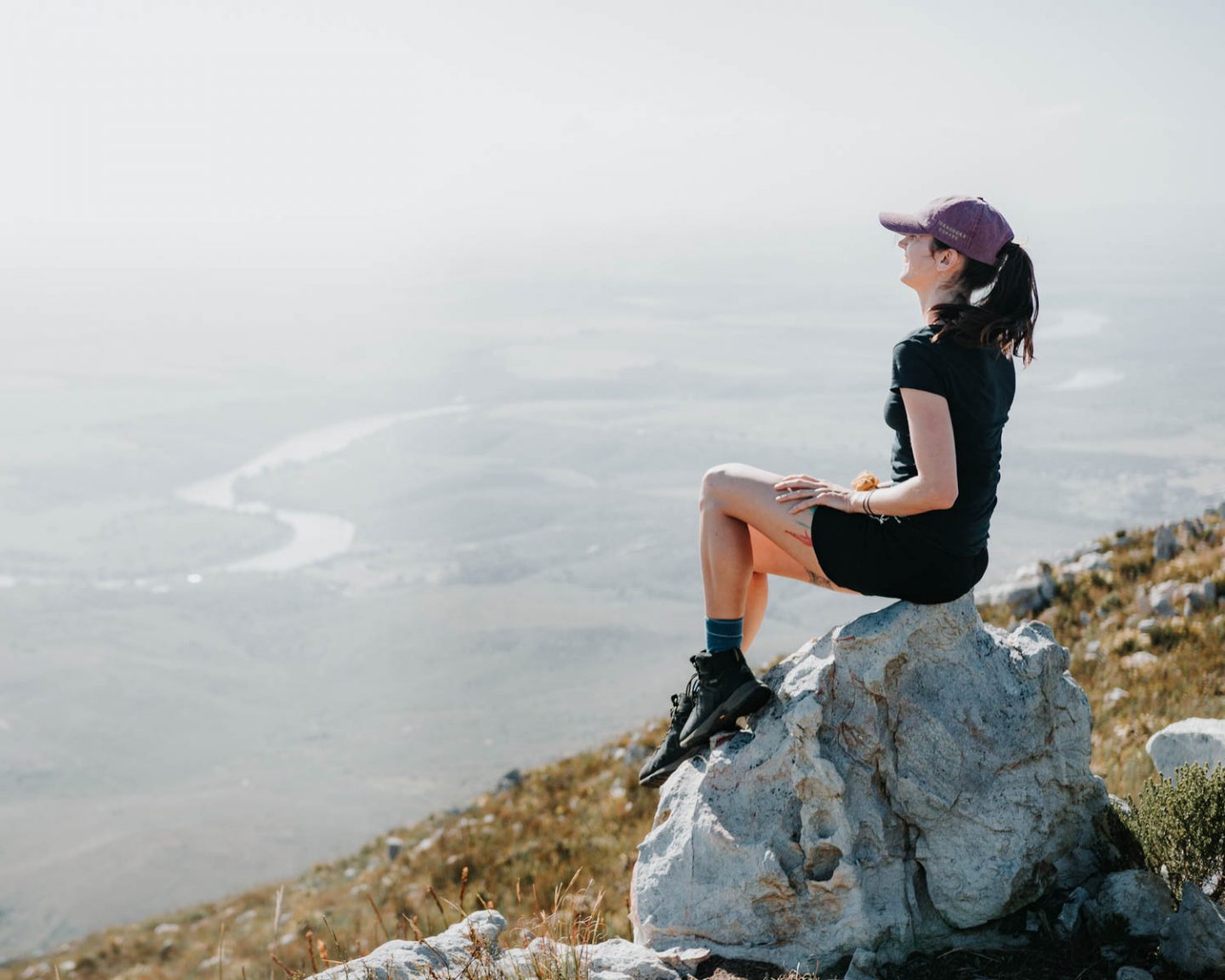 girl laughing on rock