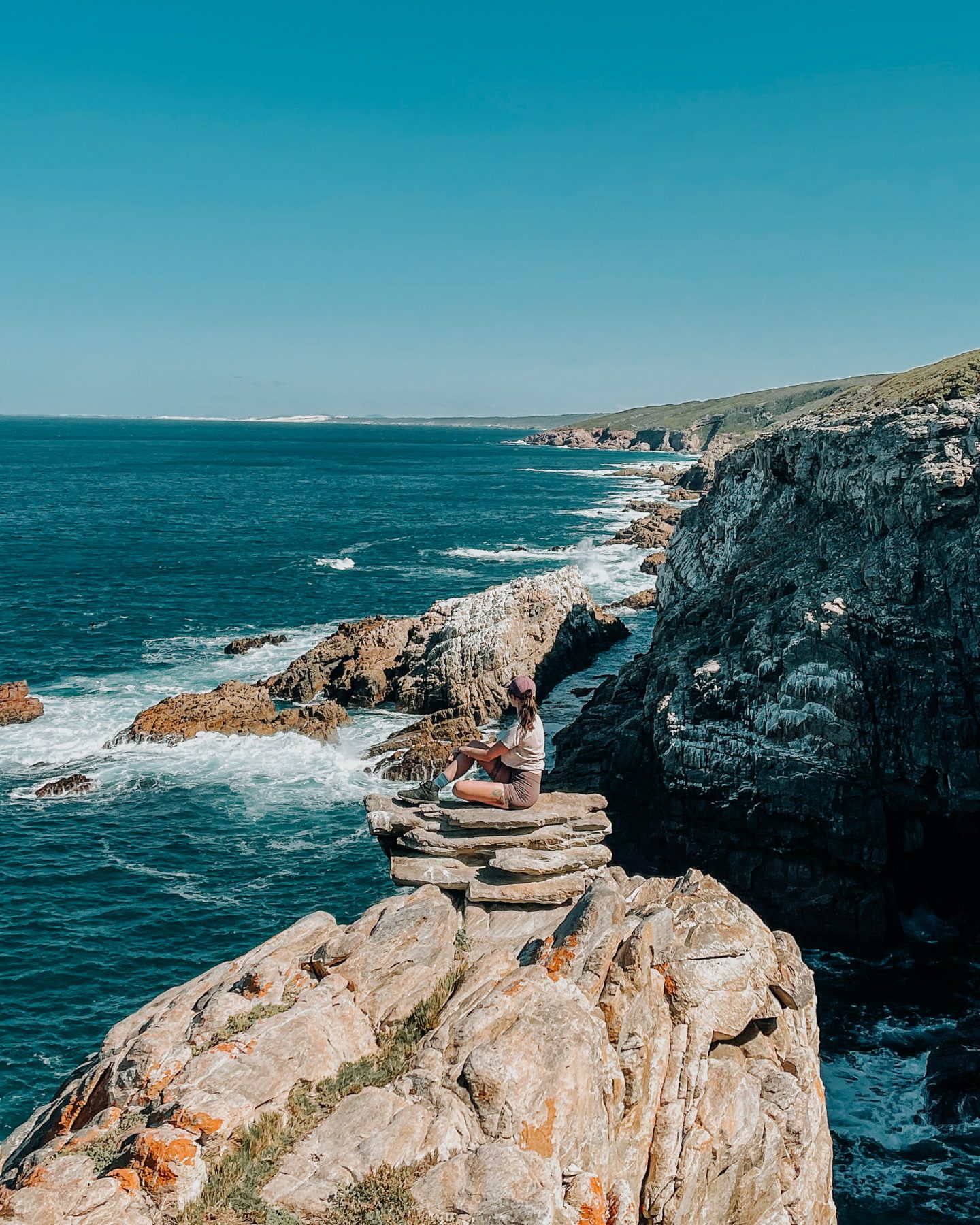 girl sitting on a cliff