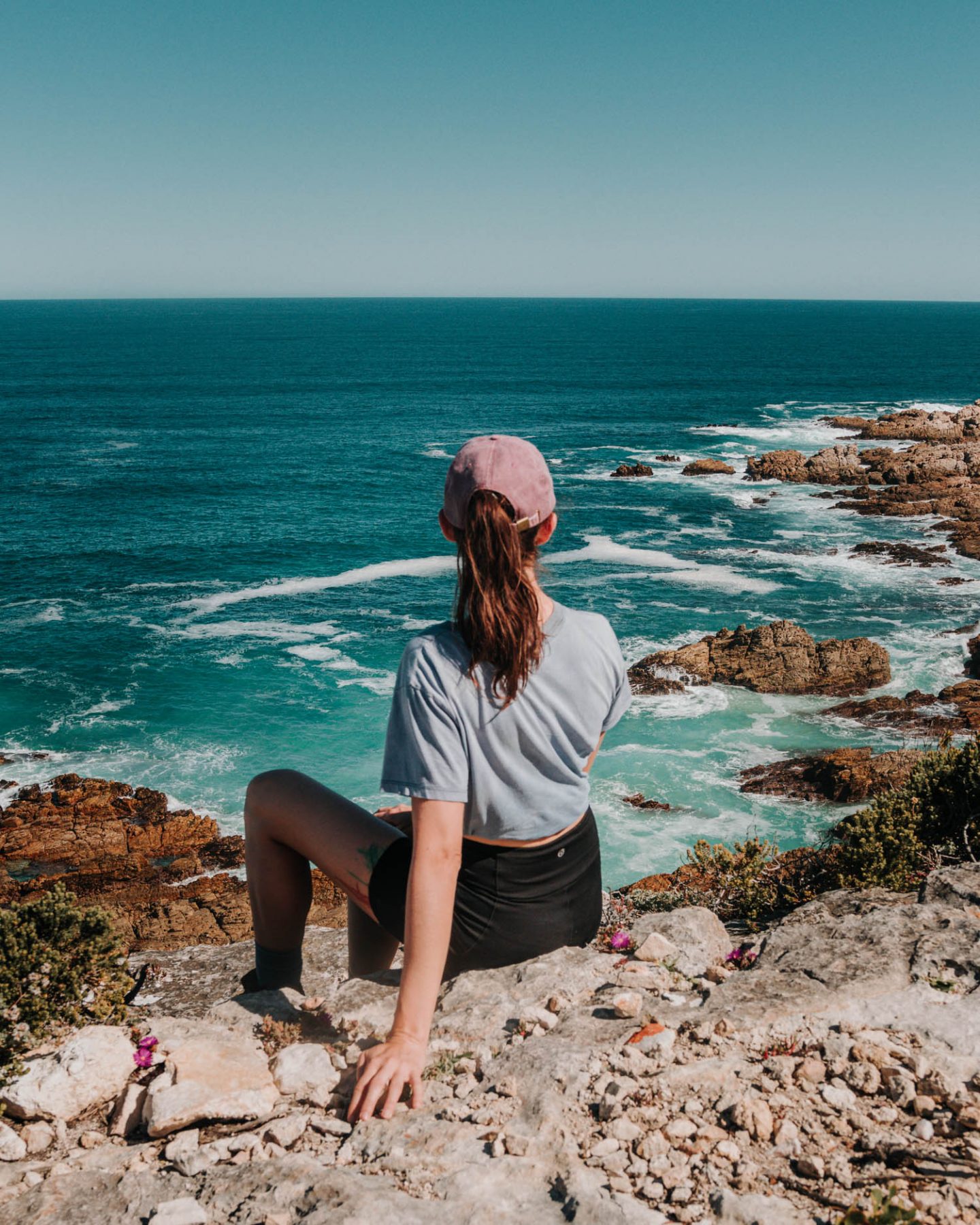 girl sitting on the top of a cliff
