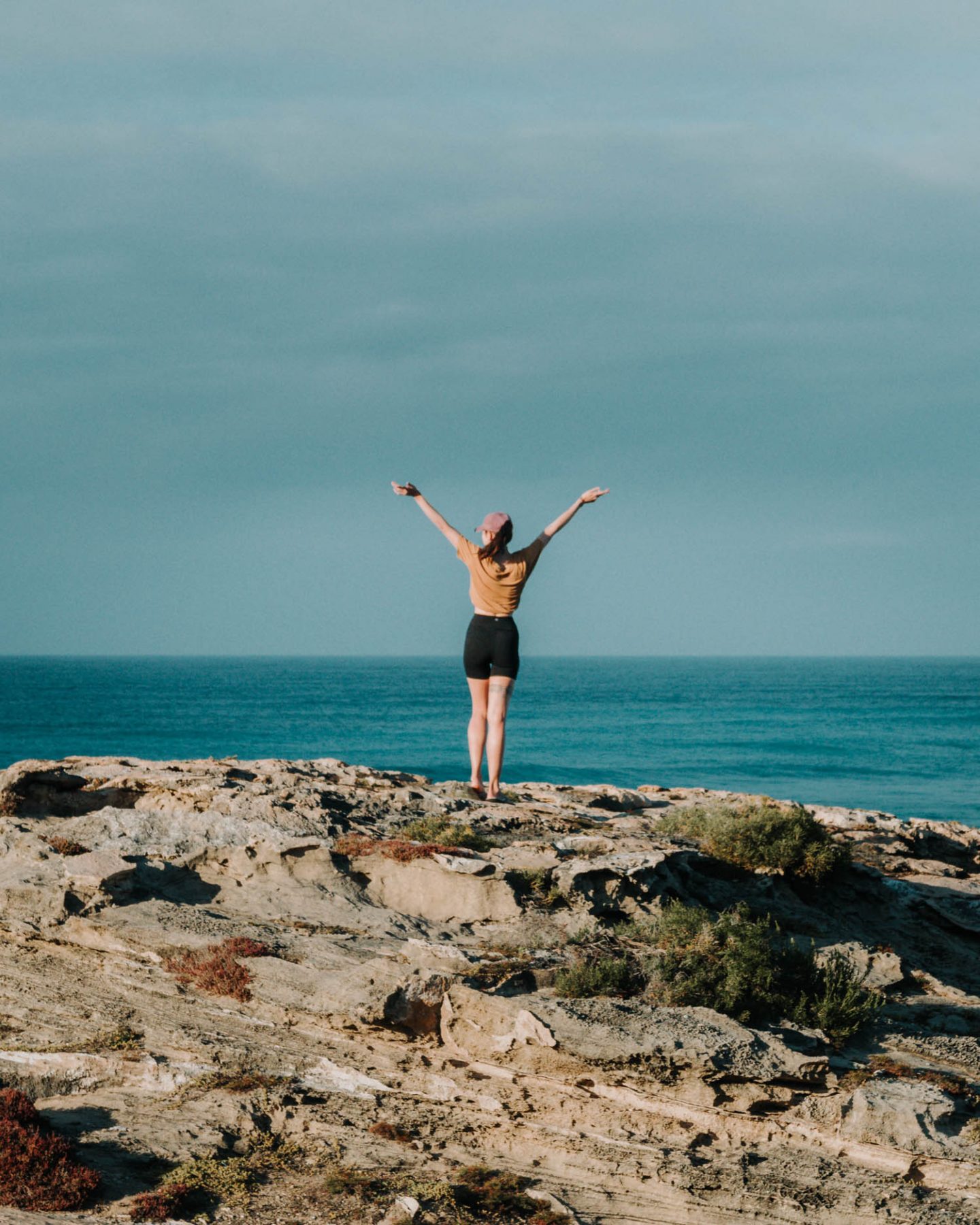 girl standing on a rock