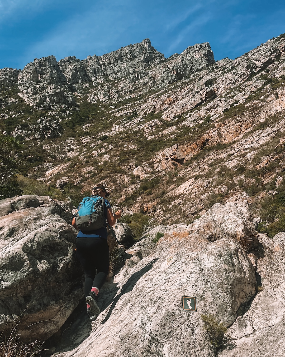 woman rock scrambling on hike