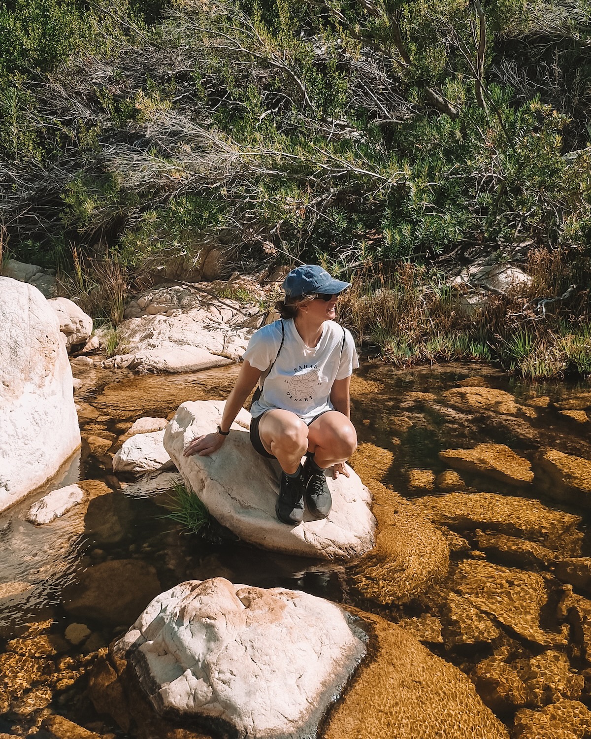 woman sitting on rock